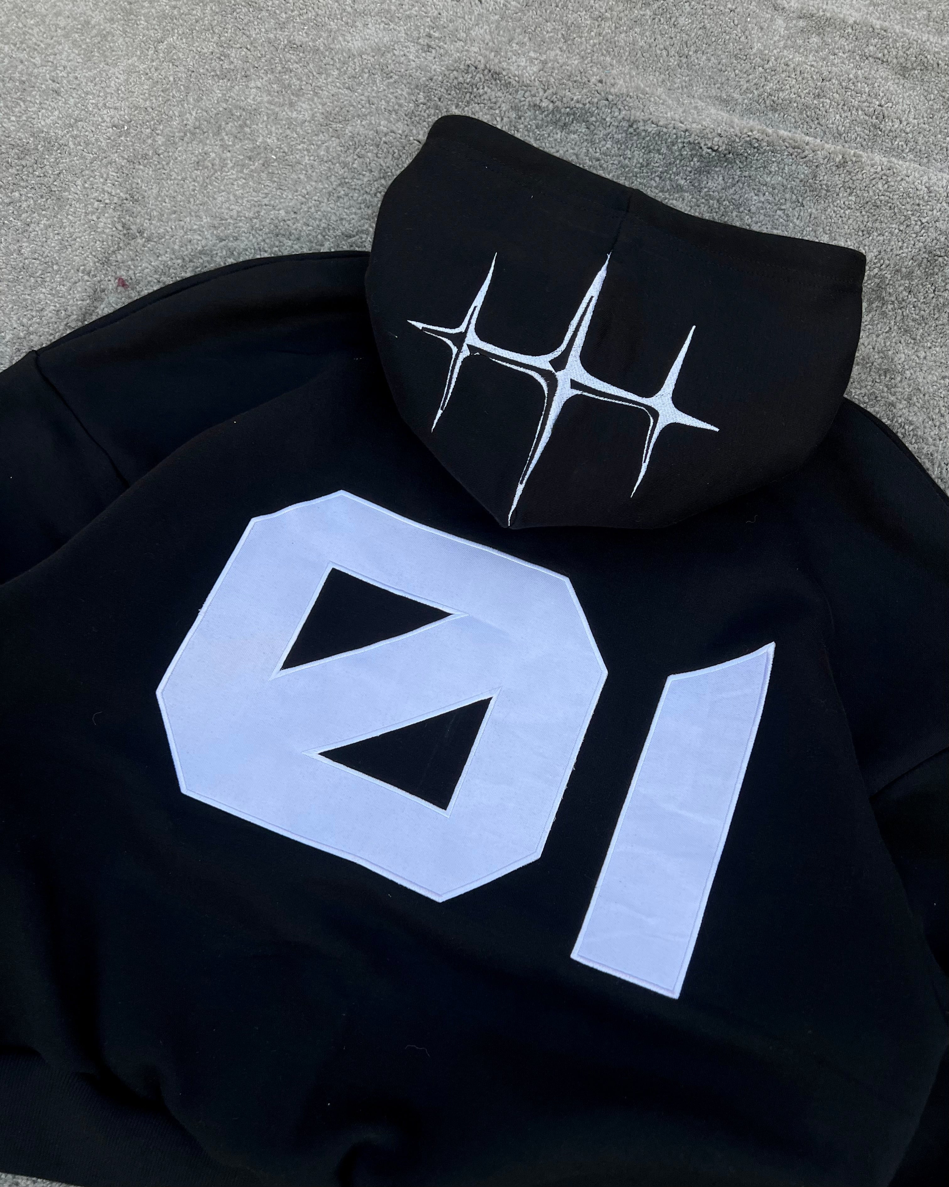 Black embroidered sweatsuit rear view showing hoodie and jogger fit