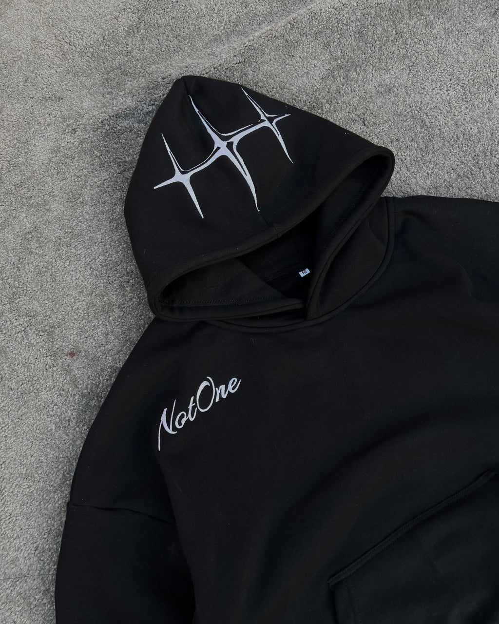 Black embroidered Never Alone hoodie product view