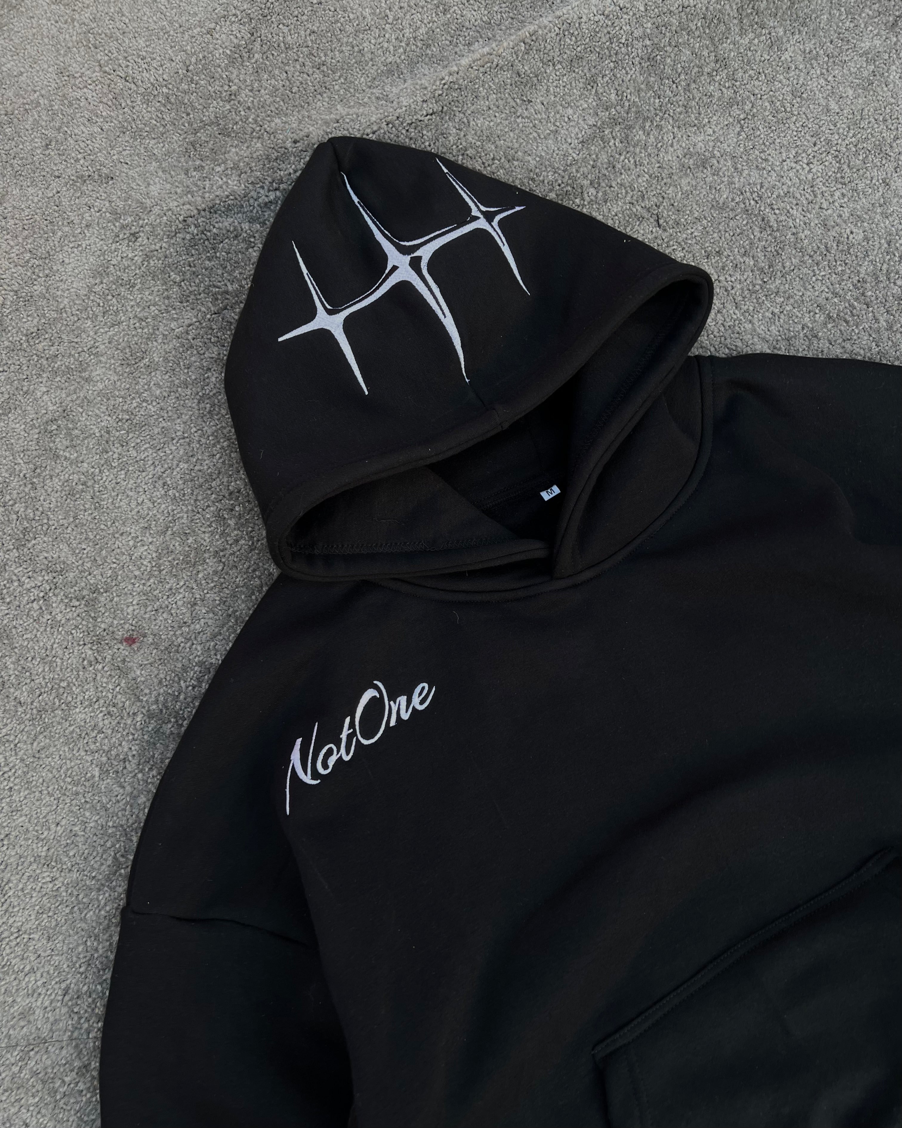Black embroidered Never Alone hoodie product view