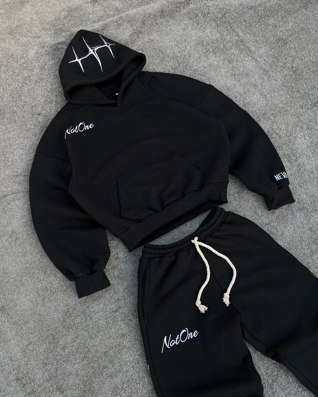 Black jogger pants with embroidered Never Alone logo